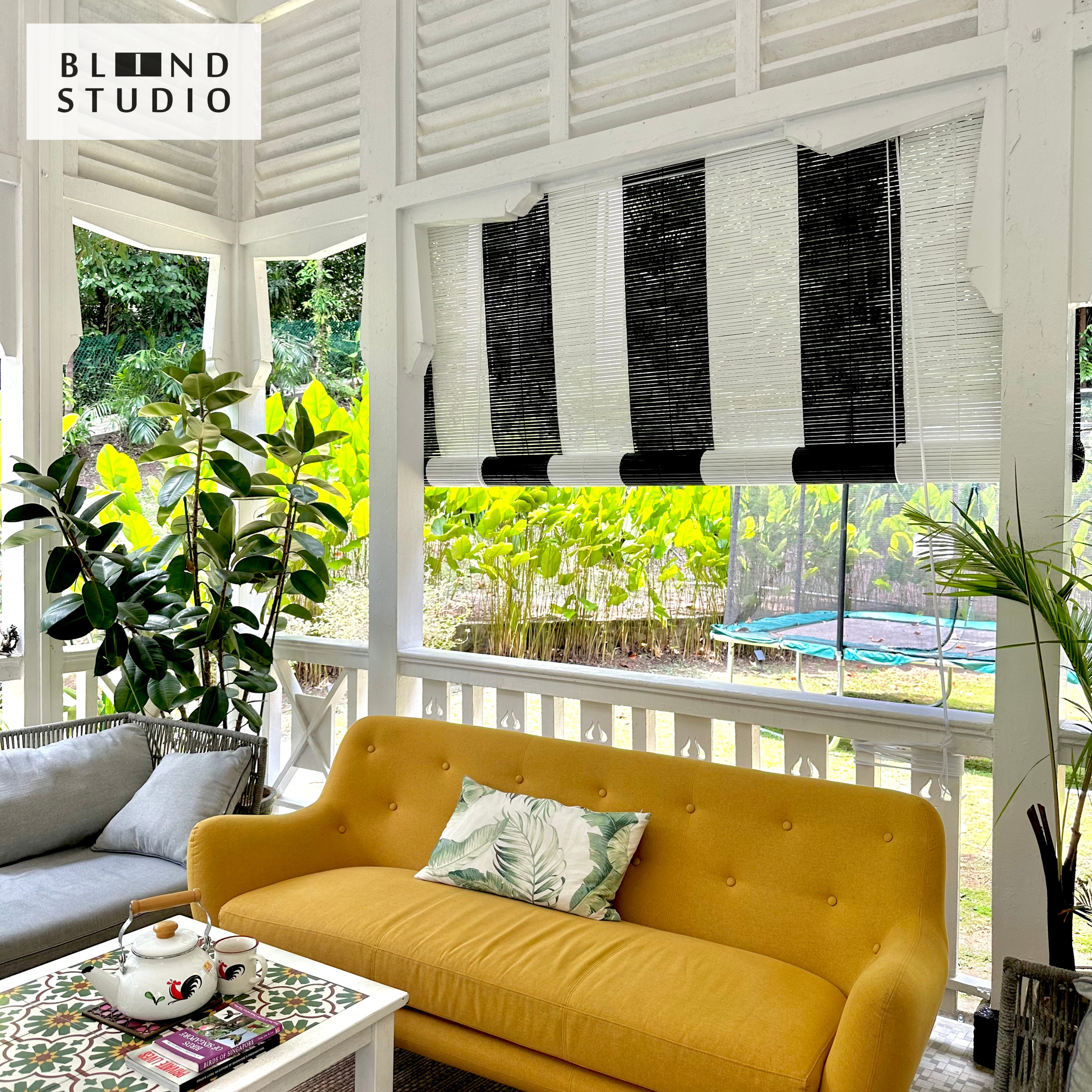 Black and white bamboo blinds with havana style interior design, yellow sofa, small house palm. Best for colonial house