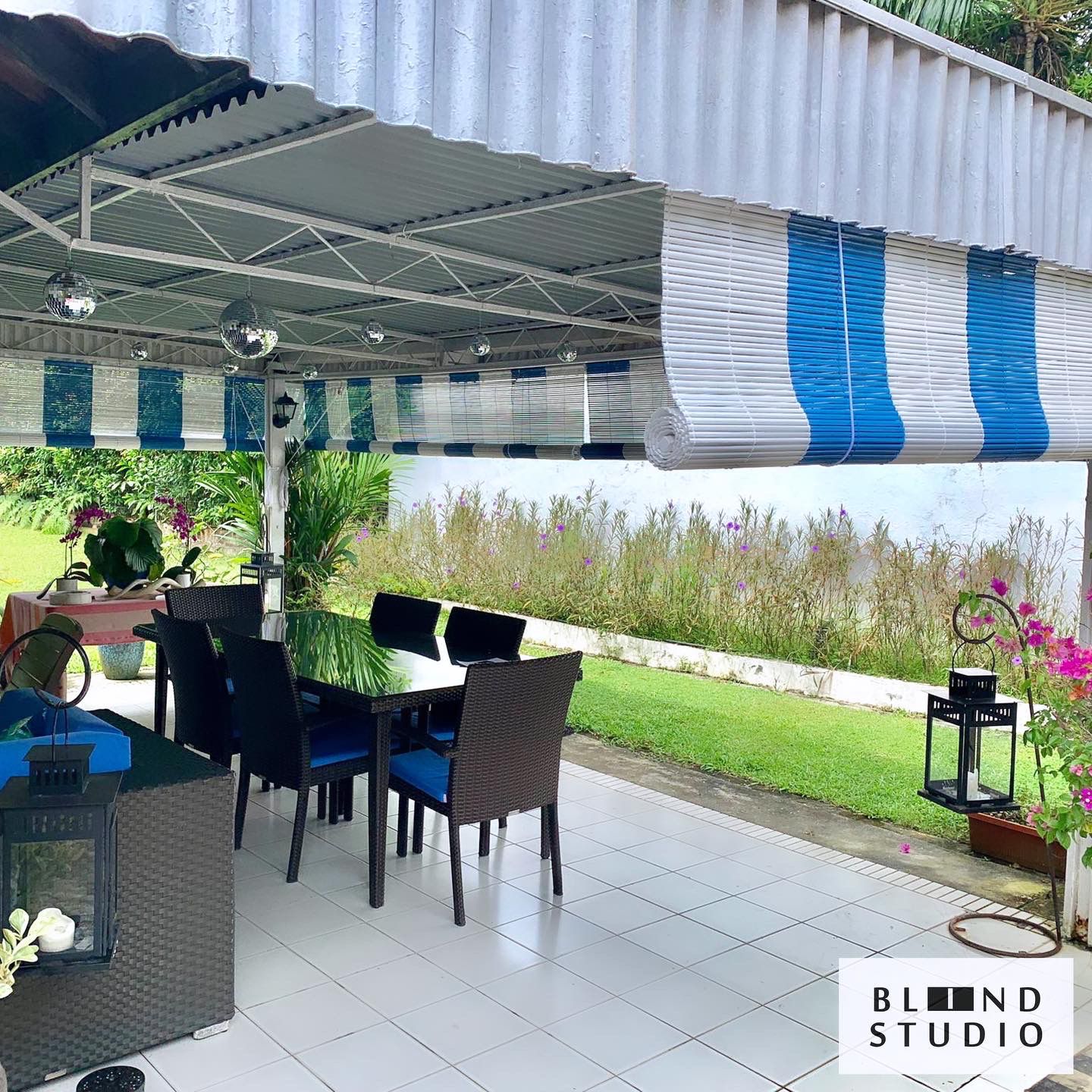 Blue and White Bamboo Blinds at an outdoor dining of a bungalow house